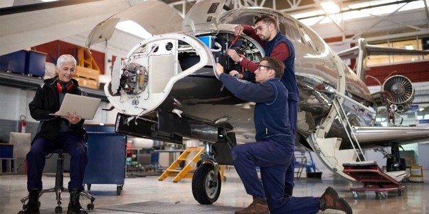 Maintenance crew working on a private jet.