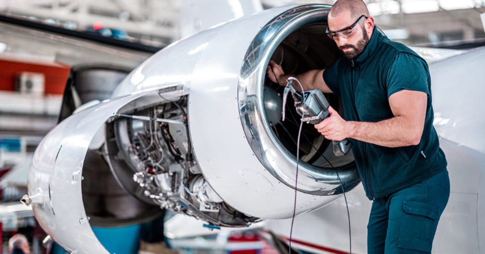 Precise engine inspection by a technician to maintain regulatory compliance.